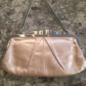 Hobo clutch handbag in pearl white/cream color.